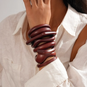 Macro shot of dark brown resin acrylic layered bracelet with organic geometric shapes