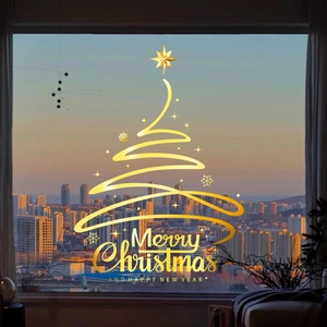 Pegatinas doradas de árbol de Navidad para ventana con copos sobre cristal y ciudad