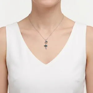 S925 sterling silver chain necklace with delicate blue flower fairy pendant on a model