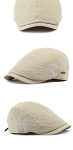 Detail view of beige breathable ivy cap with waffle texture and metal logo plaque