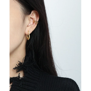 Minimalist gold U-shaped irregular hoop earring and twisted double layer ear cuff on model
