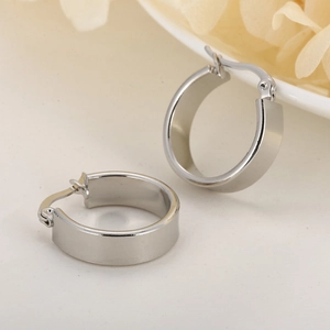 Close-up of minimalist stainless steel wide U-shaped hoop earrings with polished finish