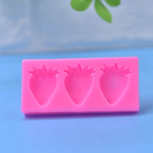 Pink silicone mold with three strawberry shapes for DIY cake baking and chocolate making