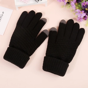 Detail of black knitted touchscreen gloves showing grey conductive tips and ribbed cuffs