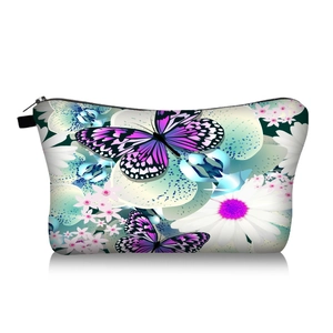 Detail of butterfly and orchid print on travel makeup bag with zipper and handle