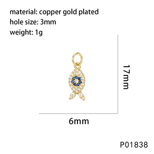 Macro view showing 17x6mm gold plated fish pendant dimensions and blue gemstone detail