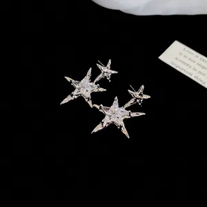 Sparkling silver star stud earrings with brilliant zircon stones on a black background