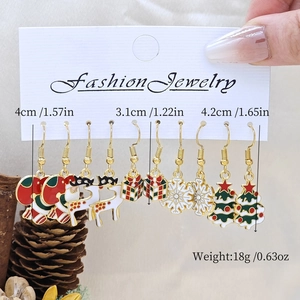 Christmas earring set showing sizes of snowman, reindeer and tree designs on card