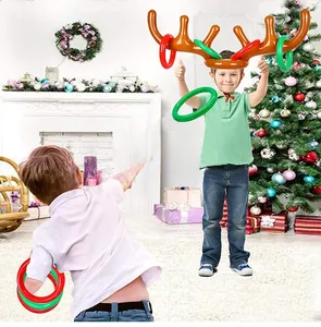 Kids playing with inflatable reindeer antler toss game rings in a festive Christmas room