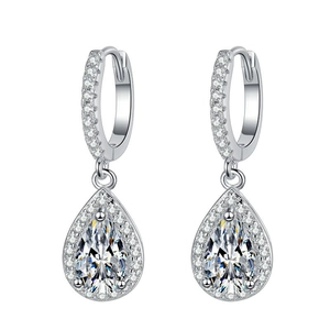Macro shot of silver teardrop earrings with pear-cut cubic zirconia and pavé halo detail