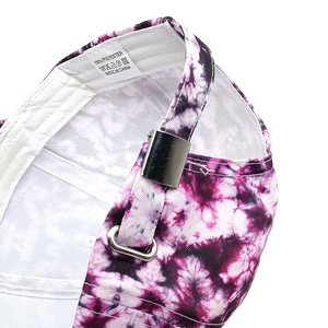 Detail of pink-purple tie-dye baseball cap featuring adjustable silver buckle and 100% polyester label