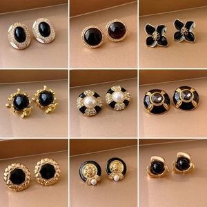 Vintage 9-piece black gold earring set with pearls and Medusa head design