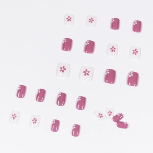 Glossy pink and white floral press-on nails with minimalist five-petal flower designs