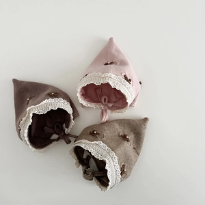 Nordic knitted baby hats with lace trim and bow in pink, brown, and khaki colors