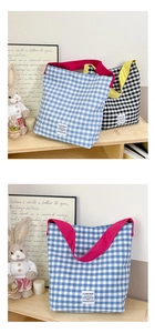 Détail de sacs cabas en toile à carreaux bleu et noir avec anses contrastées vives