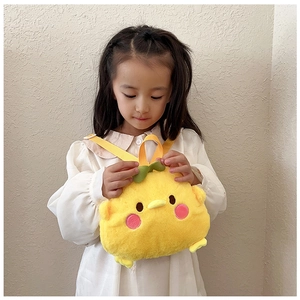 Detail of yellow plush cartoon chicken backpack for kids with soft texture and green leaf