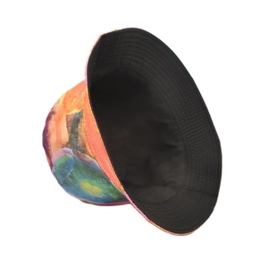 Detail of reversible bucket hat showing colorful tie-dye print and black inner lining