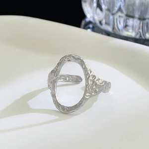 Detail of silver irregular hammered texture and hollow oval design on open ring