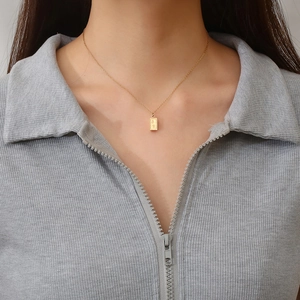 Minimalist gold bar pendant necklace featuring engraved Chinese characters on fine chain