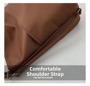 Detail show of wide comfortable shoulder strap and lychee grain brown leather texture