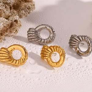 Textured spiral hoop earrings in 18k gold and silver finish with minimalist style