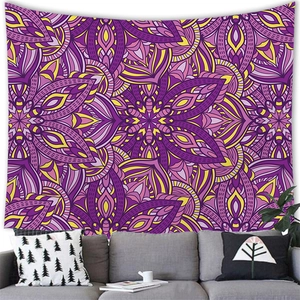 Detail of bohemian mandala tapestry with purple and yellow patterns above a modern sofa