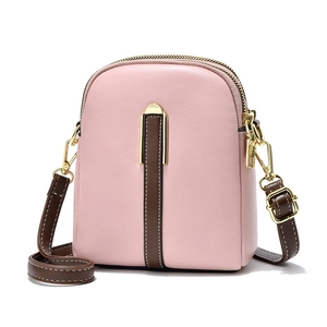 Pink PU leather crossbody bag with brown contrast strap and gold zipper details