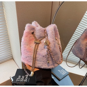 Detail of plush bucket bag featuring purple gradient fur, star sequins, and pearl drawstrings