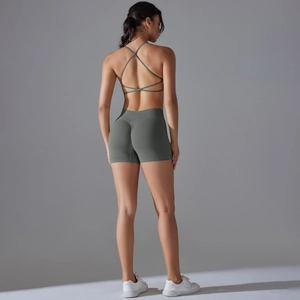 Rear view of dark green yoga set featuring cross-strap bra and scrunch butt lifting shorts