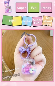 Detail view of purple mini backpack liquid keychain with colorful beads and bell charm