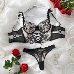 Lace lingerie set featuring floral embroidery and ribbon lace-up detail on satin