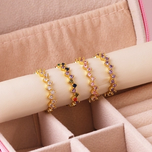 Irregular geometric gold-plated rings with colorful cubic zirconia in a jewelry box