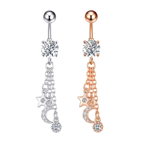Detail of silver and rose gold navel rings with hanging stars, moons, and zircon stones
