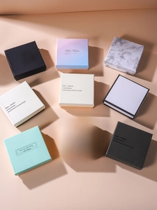 Flat lay view of various minimalist jewelry gift boxes in diverse colors and marble patterns