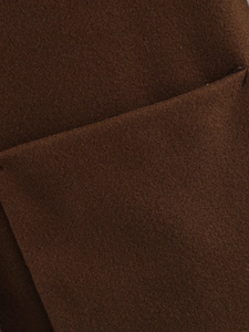 Close-up of premium dark brown wool fabric showing fine fiber texture and soft feel