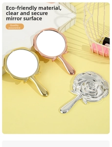 Detail view of the elegant 3D rose embossing on back of a portable handheld mirror