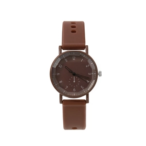 Detailed macro view of minimalist brown quartz watch dial with white numeric markers