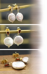 Detailed macro view of 18K gold plated earrings with baroque pearls and emerald stones