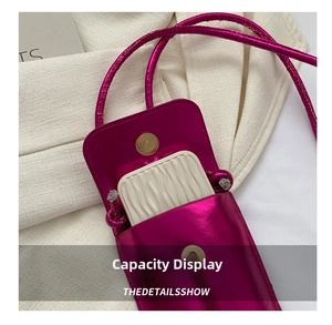 Detail of fuchsia metallic PU crossbody bag showing internal capacity and magnetic closure