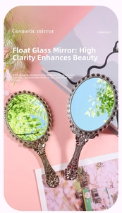 Close-up of vintage hand-held mirrors with embossed patterns and float glass in gold and silver