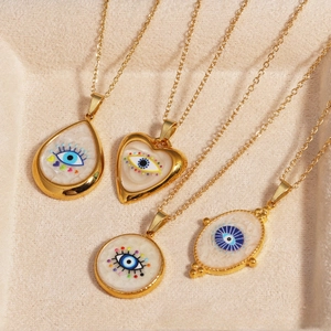 Detailed top view of evil eye necklaces in gold teardrop, heart, and round shapes