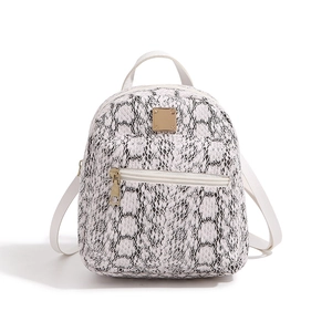 Detail of a mini backpack featuring white snake print PU leather and gold-tone hardware