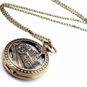 Vintage bronze pocket watch necklace featuring a detailed train relief on white background