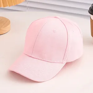 Close-up of pink cotton baseball cap with six-panel structure and breathable eyelets
