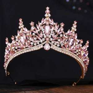 Detailed close-up of golden bridal crown with pink marquise and white crystals