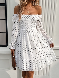 Detail of off-shoulder polka dot dress with elastic smocking and ruffle sleeve cuffs