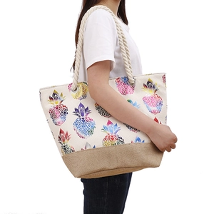 Detail of vibrant pineapple print canvas tote bag with rustic jute base and rope handles