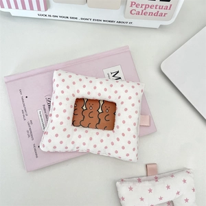 Close-up of cute plush card holder with pink polka dots and transparent window