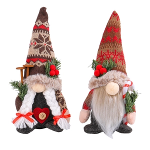Plush Christmas gnomes set with snowflake knit hats and red heart details on white background