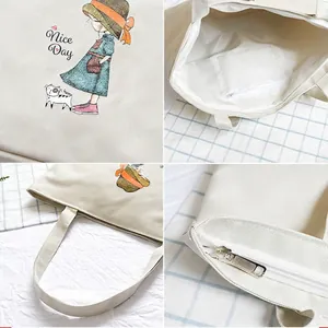 Large white canvas tote bag with cartoon girl and cat print and sturdy shoulder strap